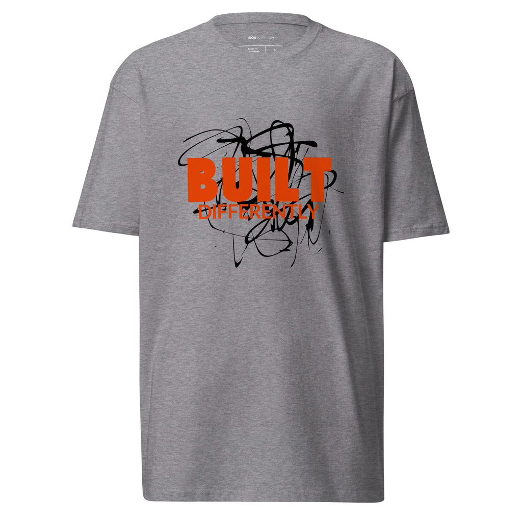 mens carbon gray color tshirt displayed on a white background with bold orange built differently text and abstract graphic design across the chest modern statement streetwear piece by iron and velvet 62