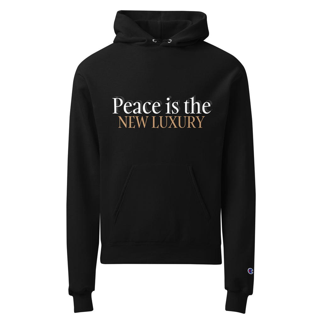black unisex hoodie displayed on a white background with peace is the new luxury text in white and light brown across the chest minimalist statement streetwear design by iron and velvet 62