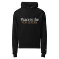 black unisex hoodie displayed on a white background with peace is the new luxury text in white and light brown across the chest minimalist statement streetwear design by iron and velvet 62